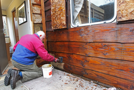 Dyfi Osprey Project volunteer paints the visitor centre